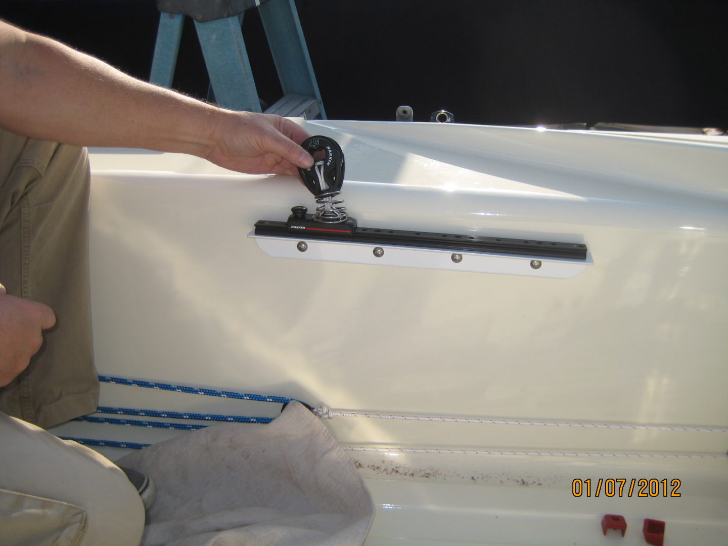 A person is cleaning the back of a boat.