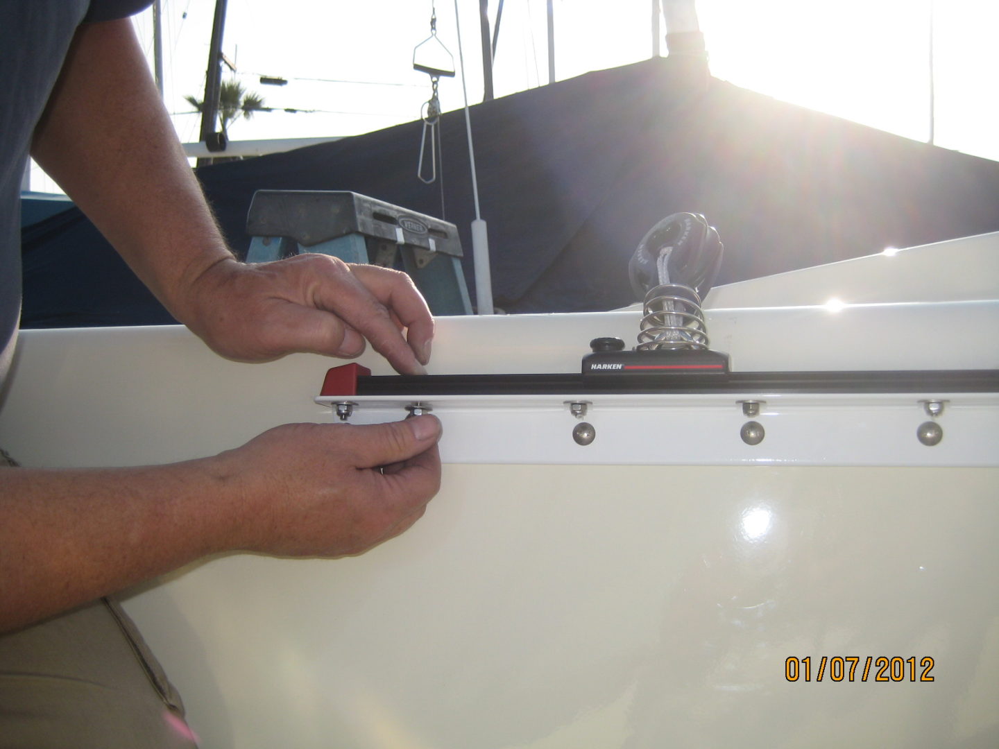 A man is holding the handle of a boat.