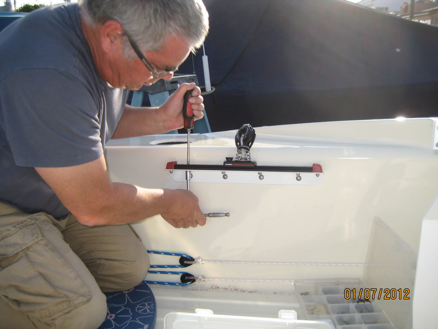 A man working on the side of a boat.