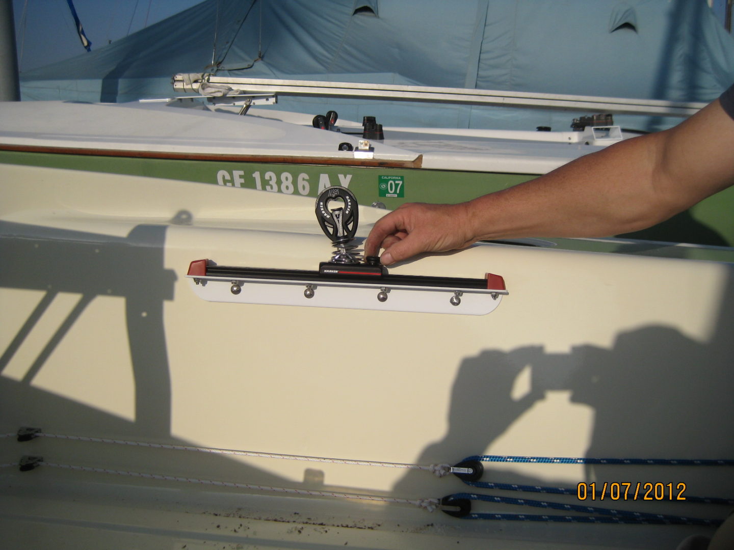 A person holding onto the handle of a boat