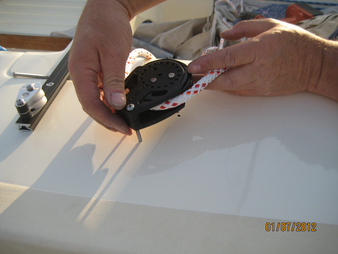 A person cutting paper with scissors on top of a table.