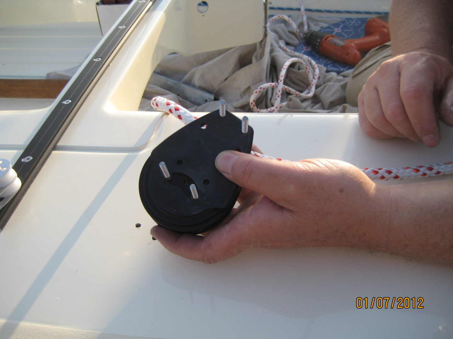 A person holding an object on top of a boat.