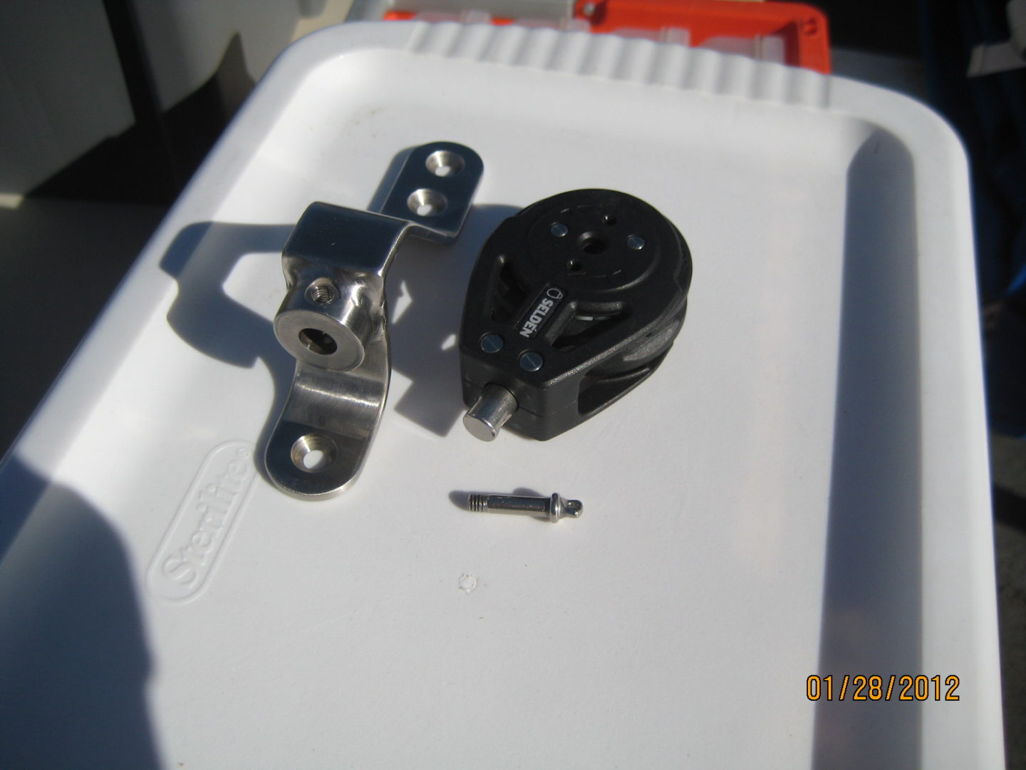 A close up of the key and lock on a white container.