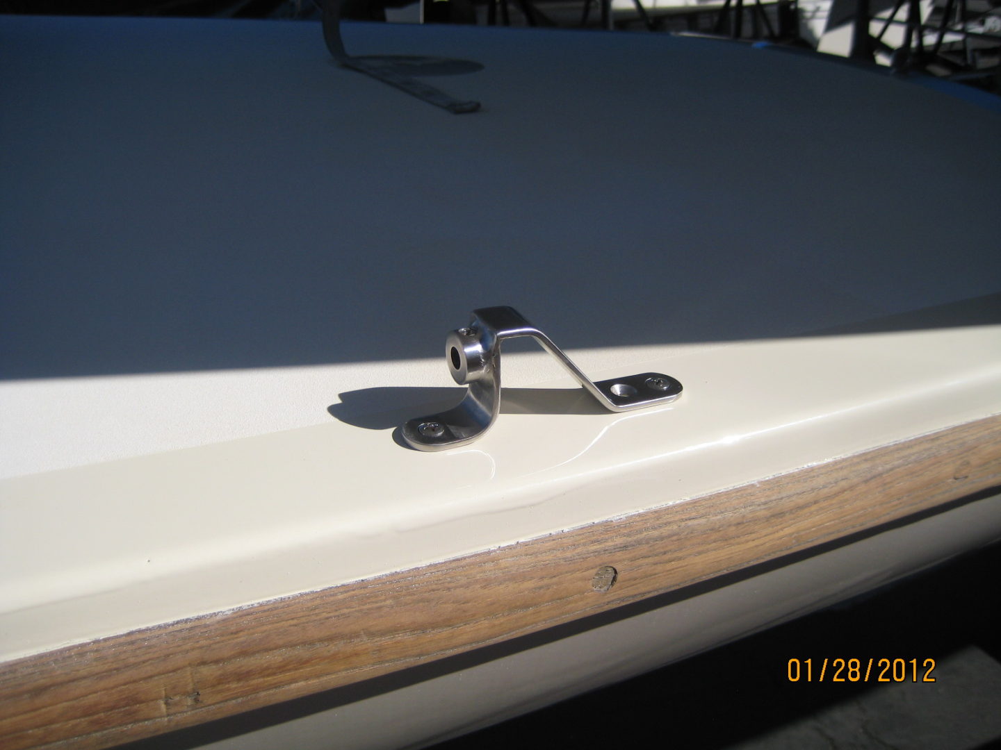 A close up of the side of a boat with a metal handle.