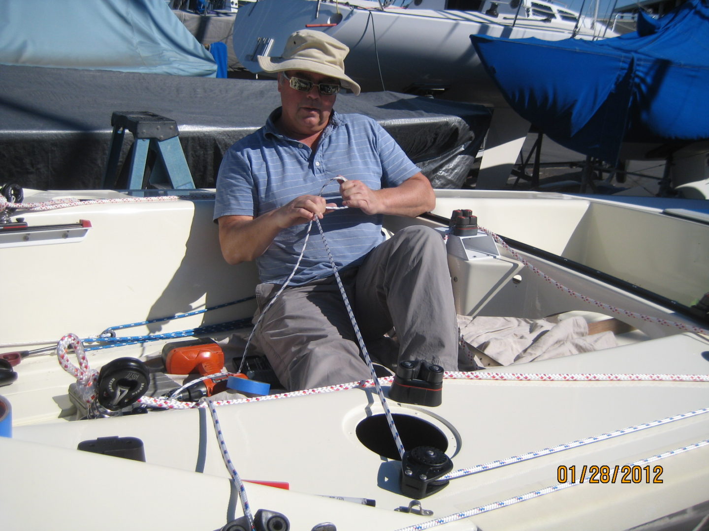 A man sitting on the back of a boat.