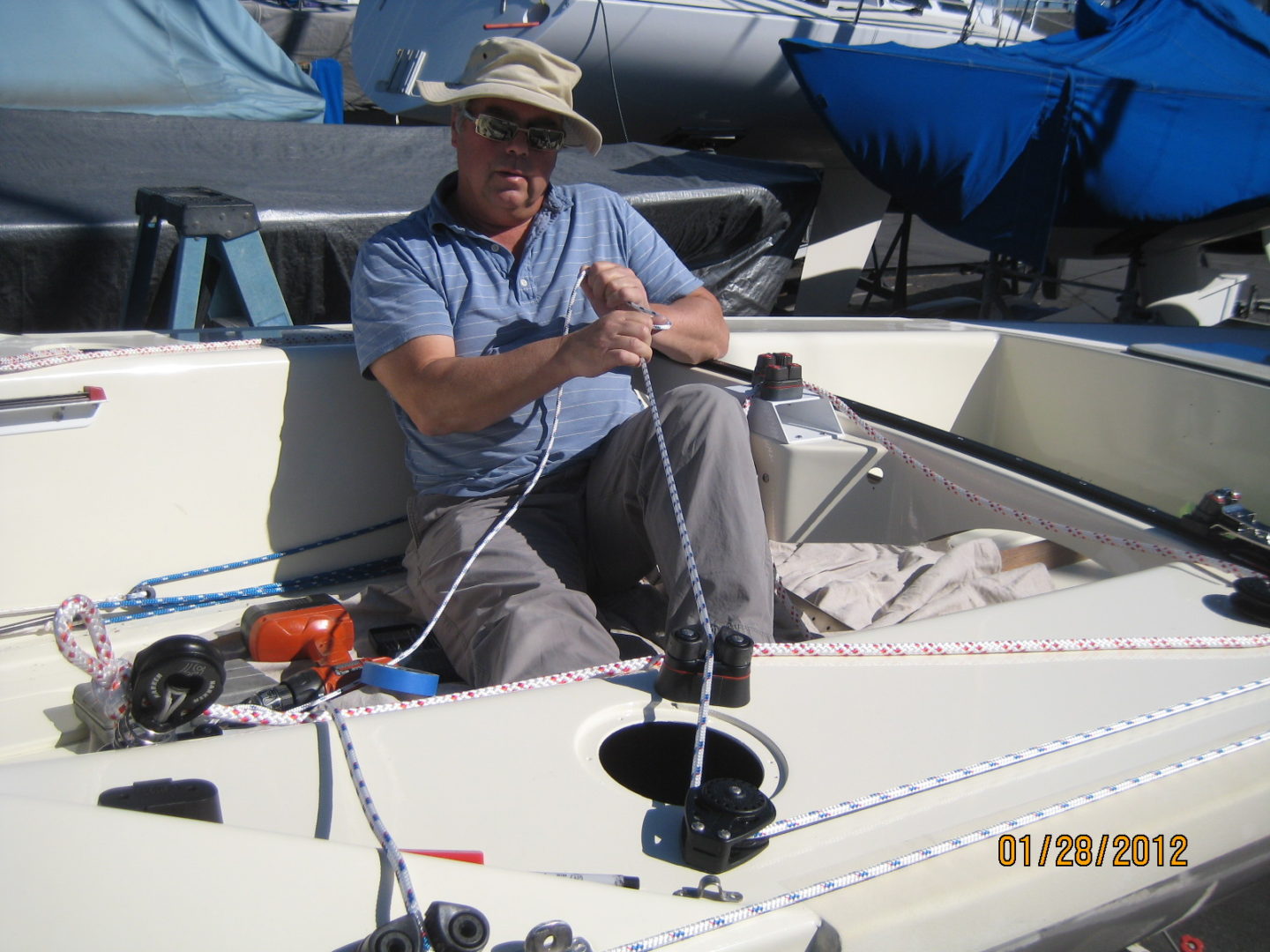 A man sitting on top of a boat in the water.