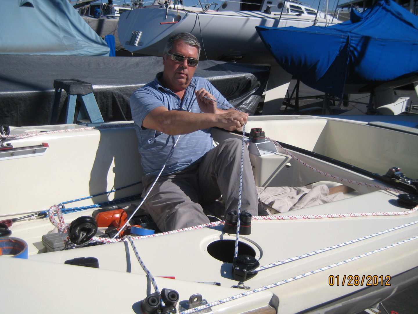 A man sitting in the back of a boat.