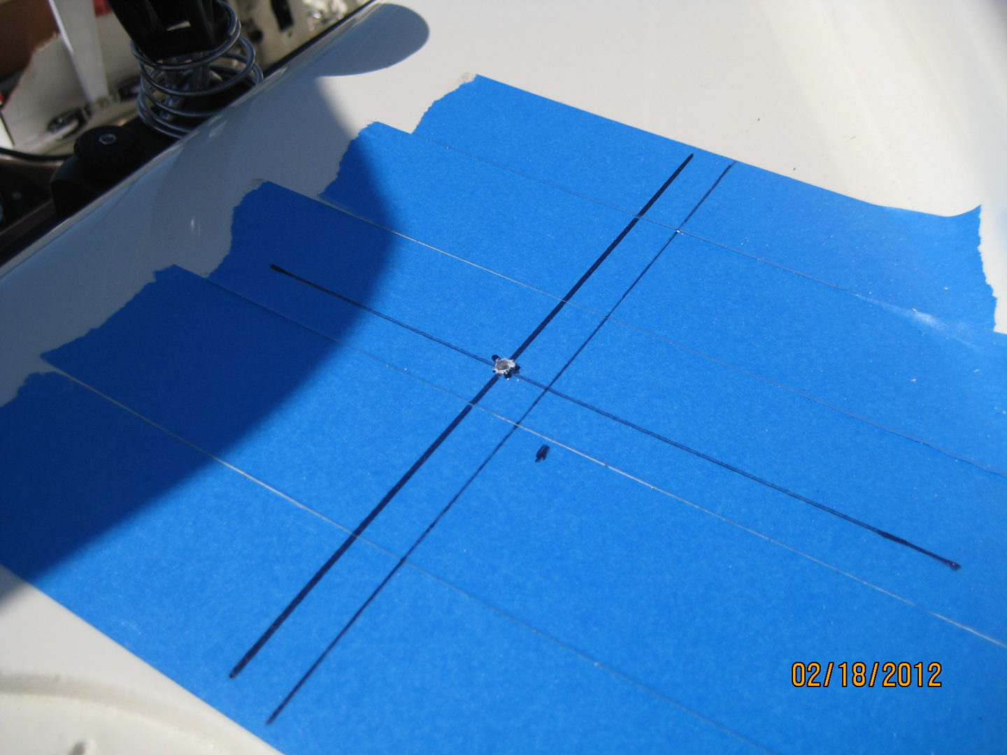 A blue sheet of paper with holes in it.