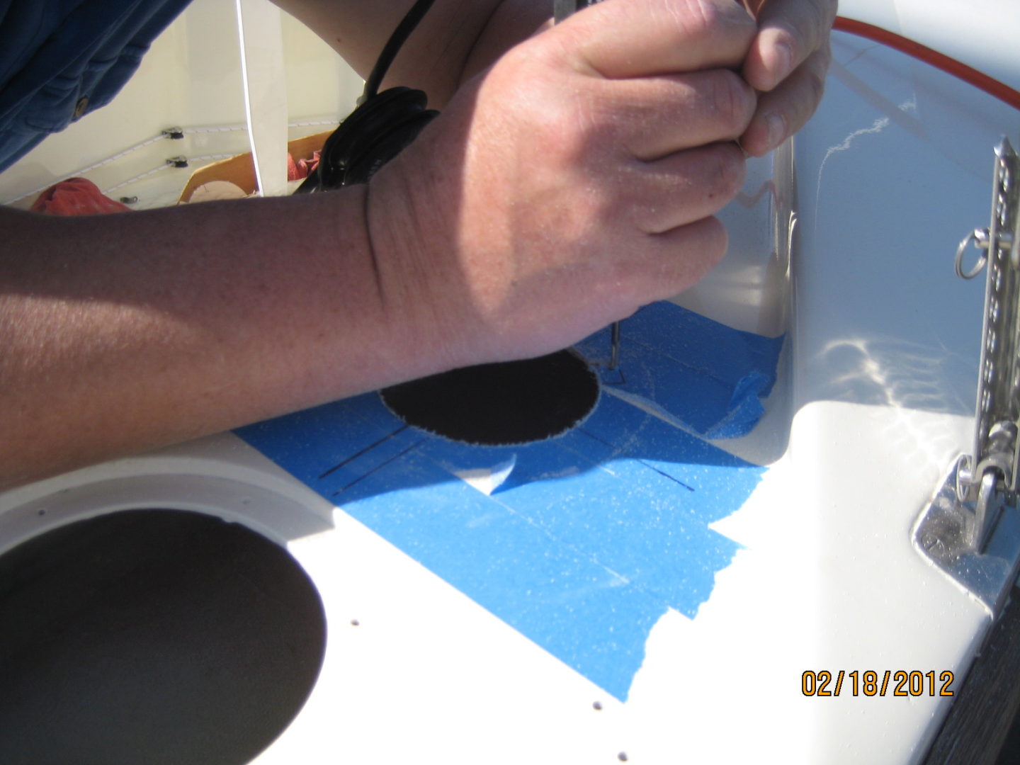 A person is painting the bottom of a boat.