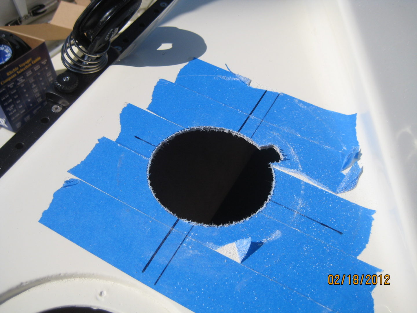 A hole in the center of a blue piece of paper.