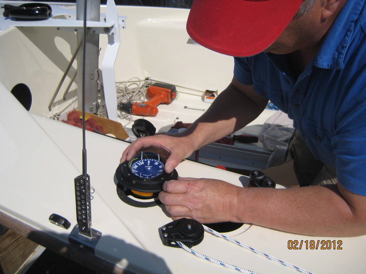 A man working on the side of a boat.