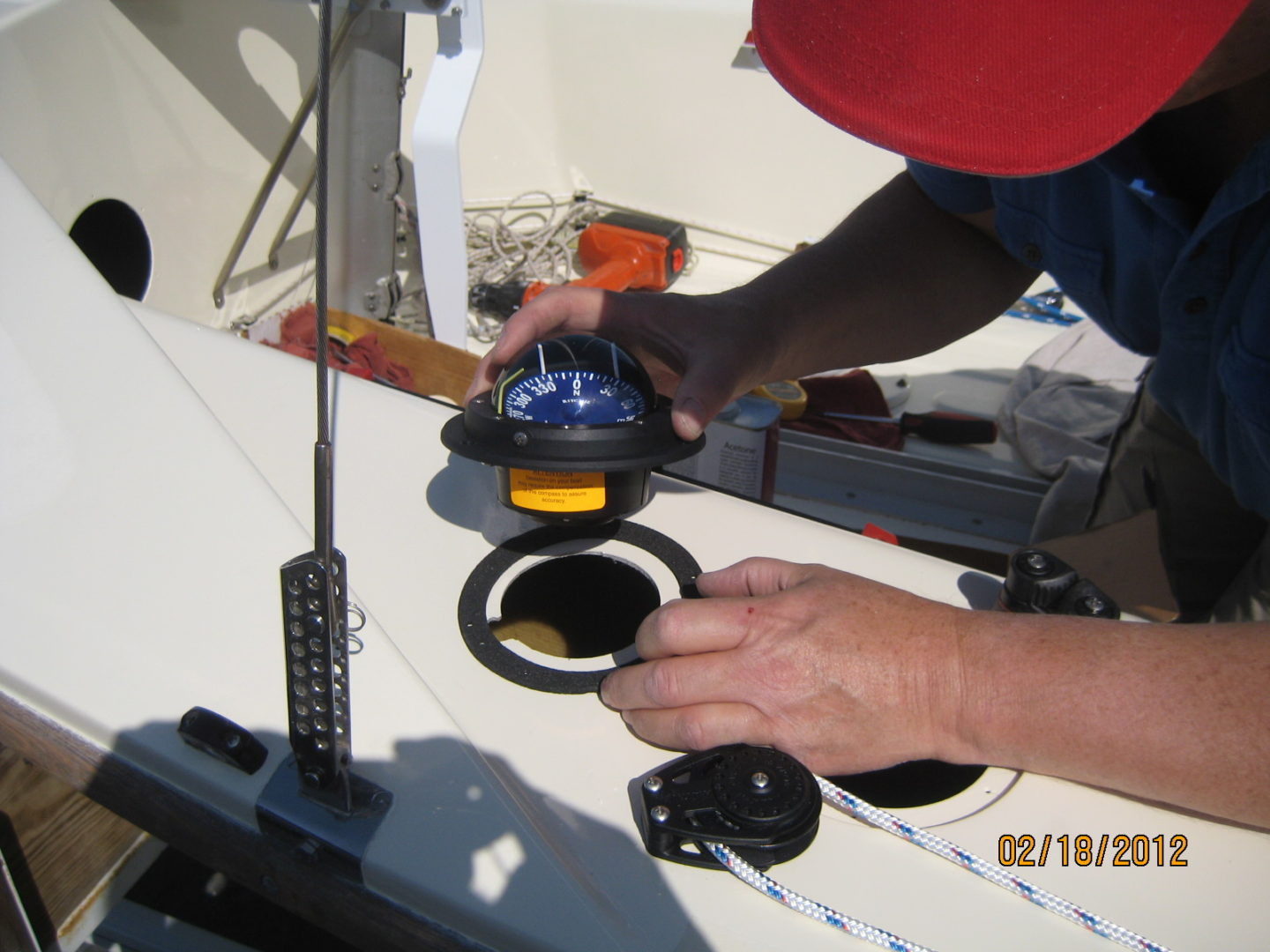 A person working on the bottom of a boat.