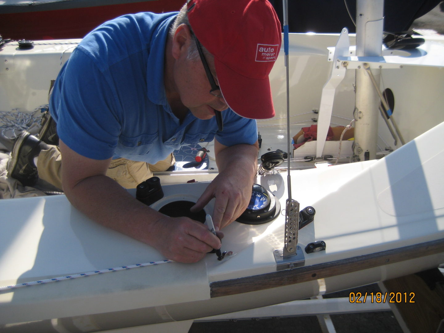 A man working on the side of a boat.