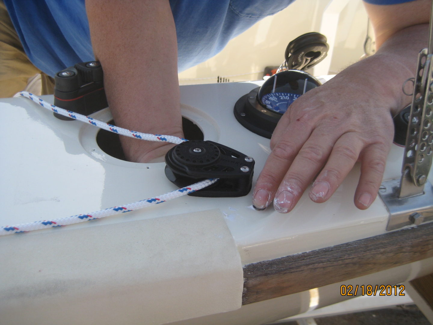 A person is working on the side of a boat.