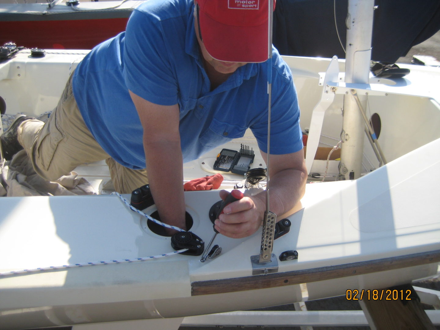 A man working on the side of a boat.