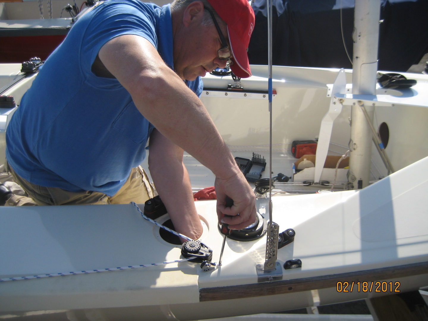 A man working on the side of a boat.