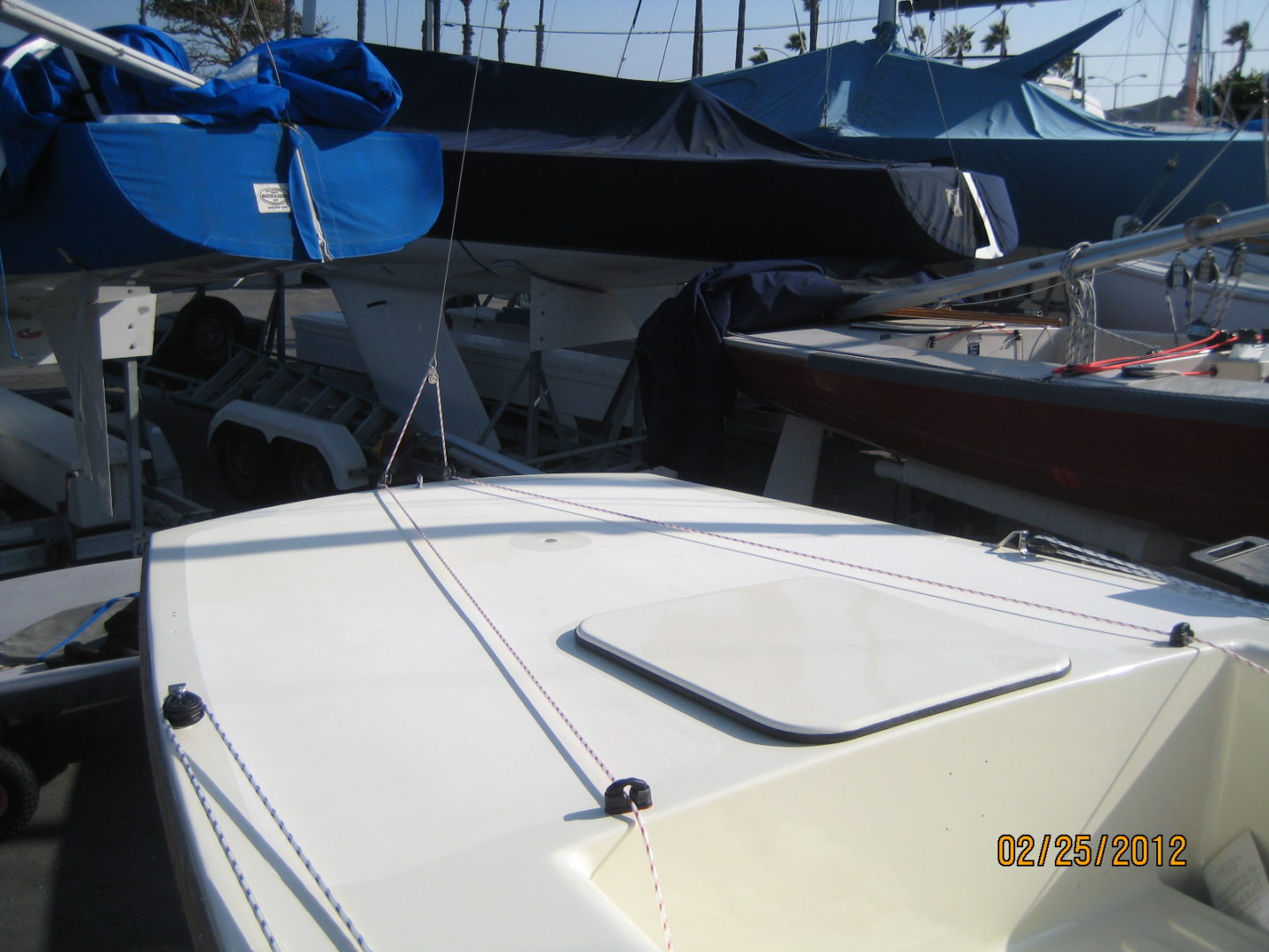 A boat is parked in the sun under some umbrellas.