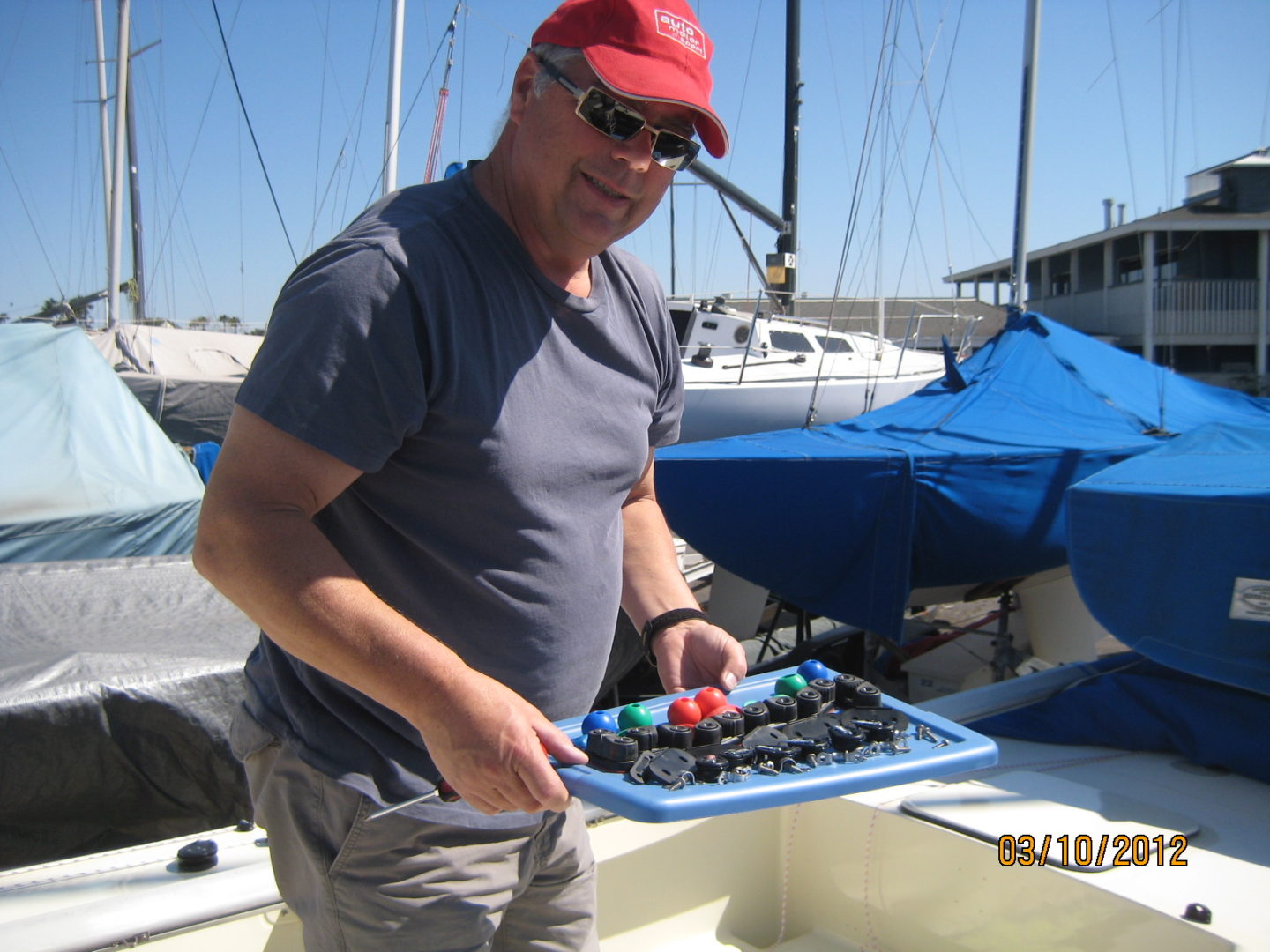 A man holding a tray of food on top of a boat.