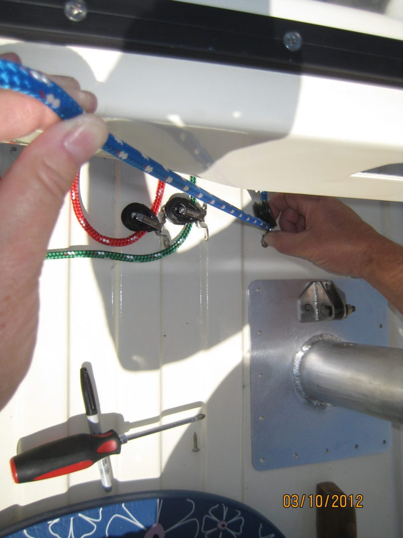 A person is working on the wires of a light fixture.