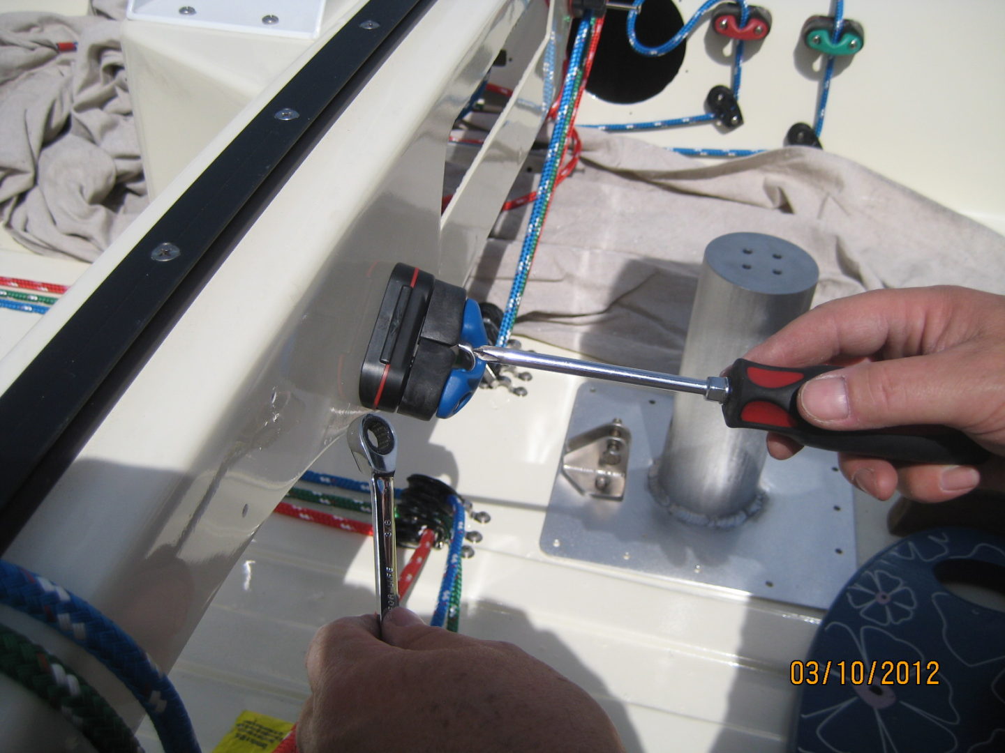 A person is working on the wires of a boat.