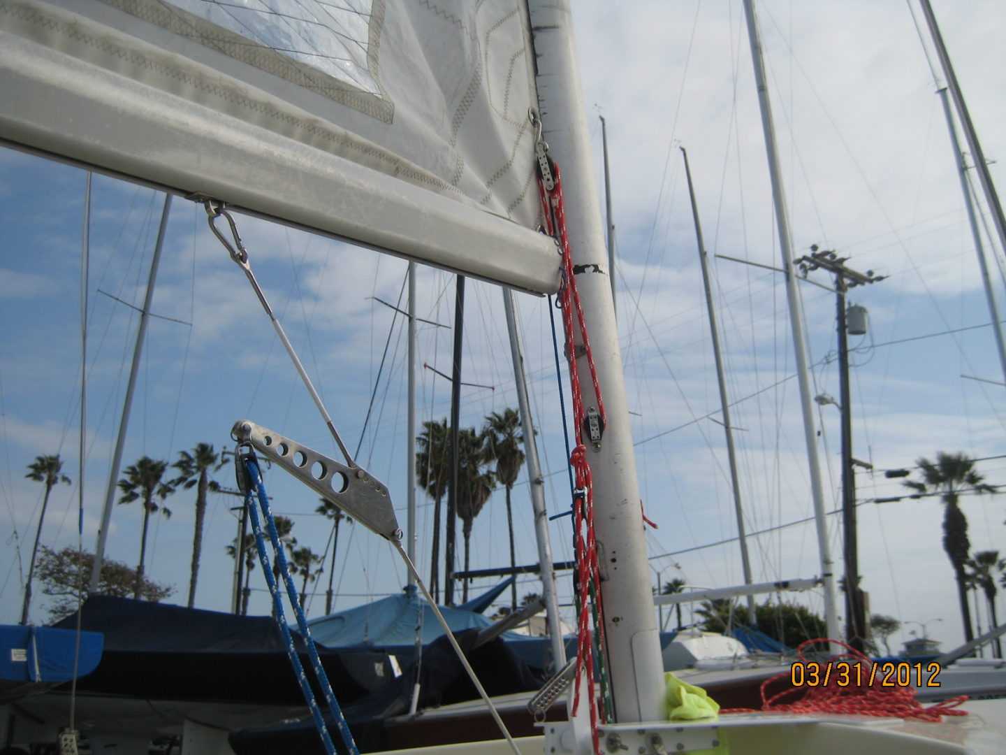 A sail boat is in the water and has sails up.