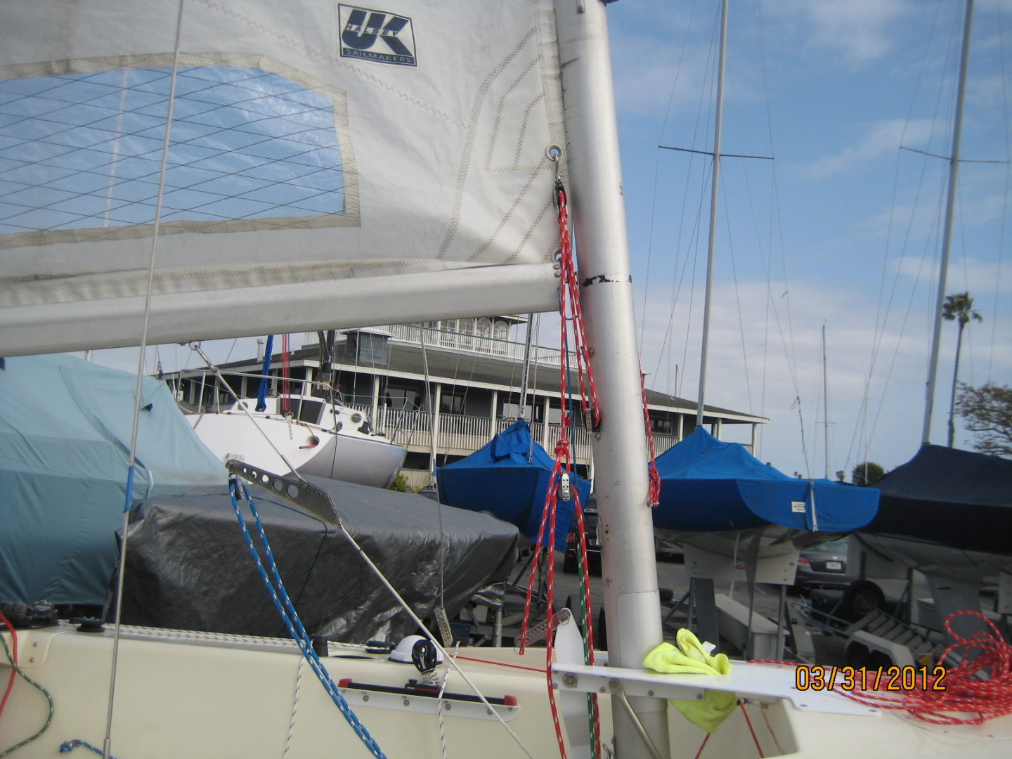 A sail boat is docked in the harbor.