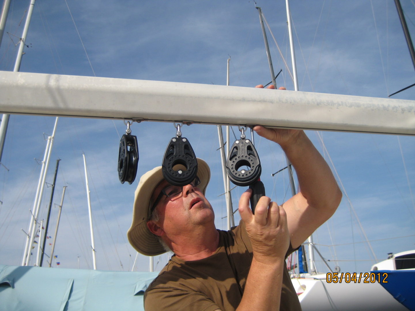 A man holding onto the ropes of a boat