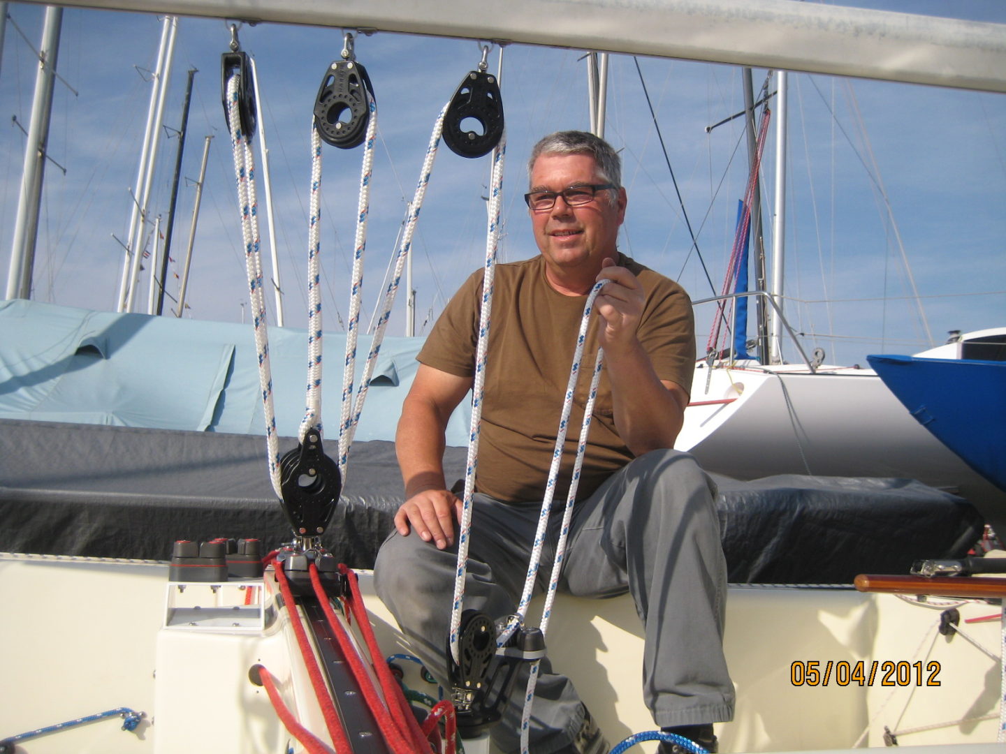 A man sitting on the deck of a boat.