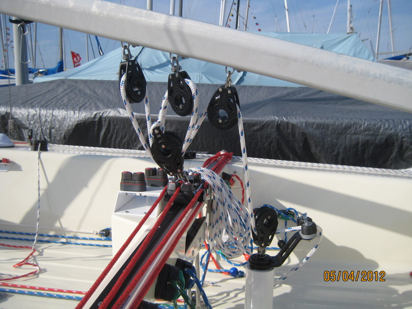 A boat with many ropes hanging from it's deck.