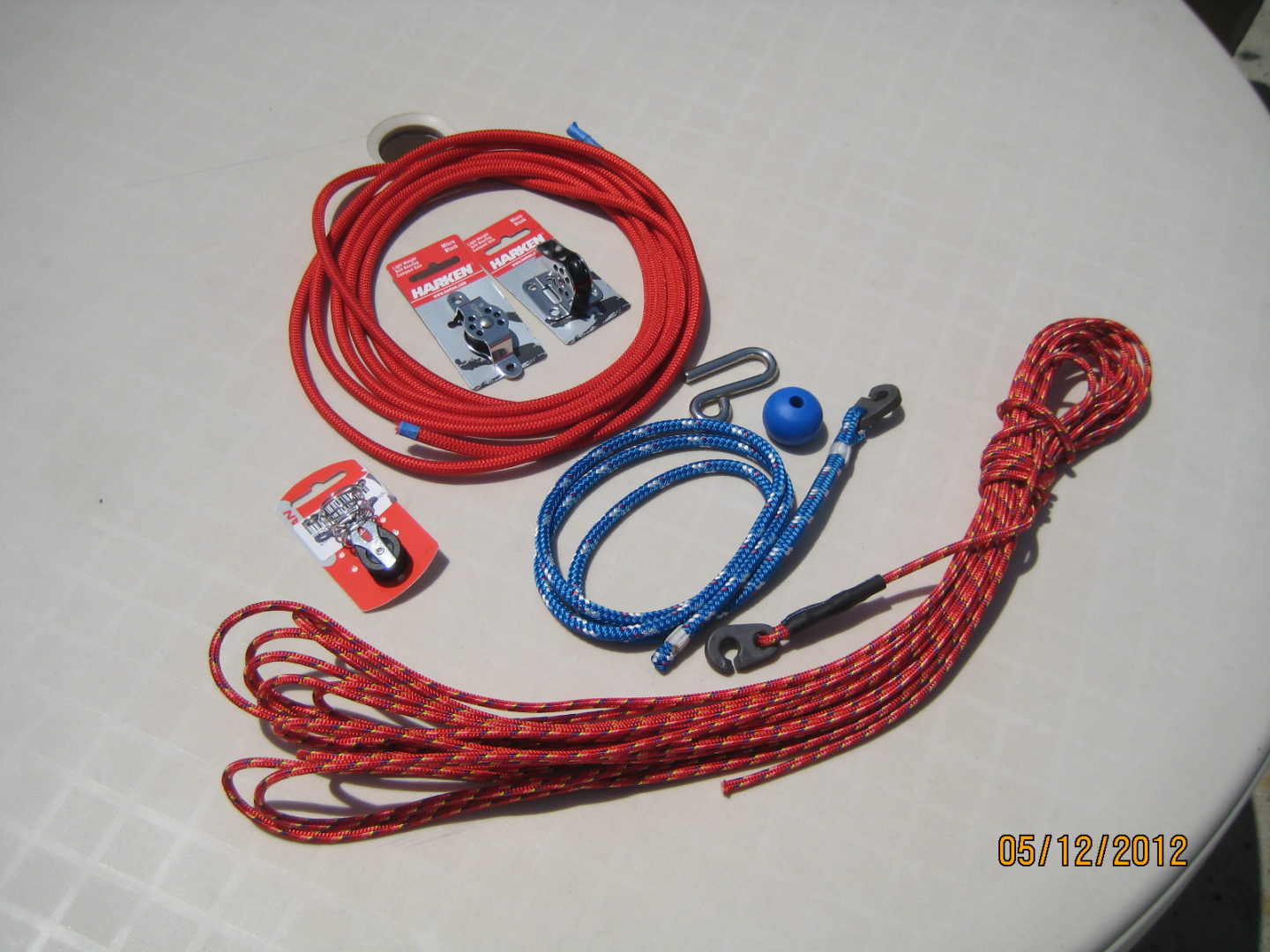 A group of ropes and cords are laying on the floor.