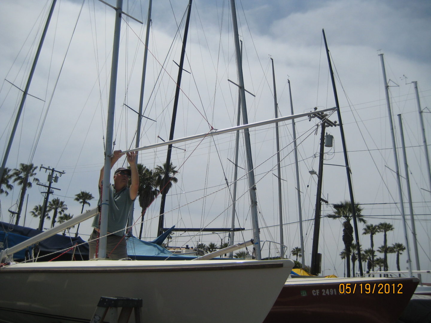 A man standing on the bow of a boat.