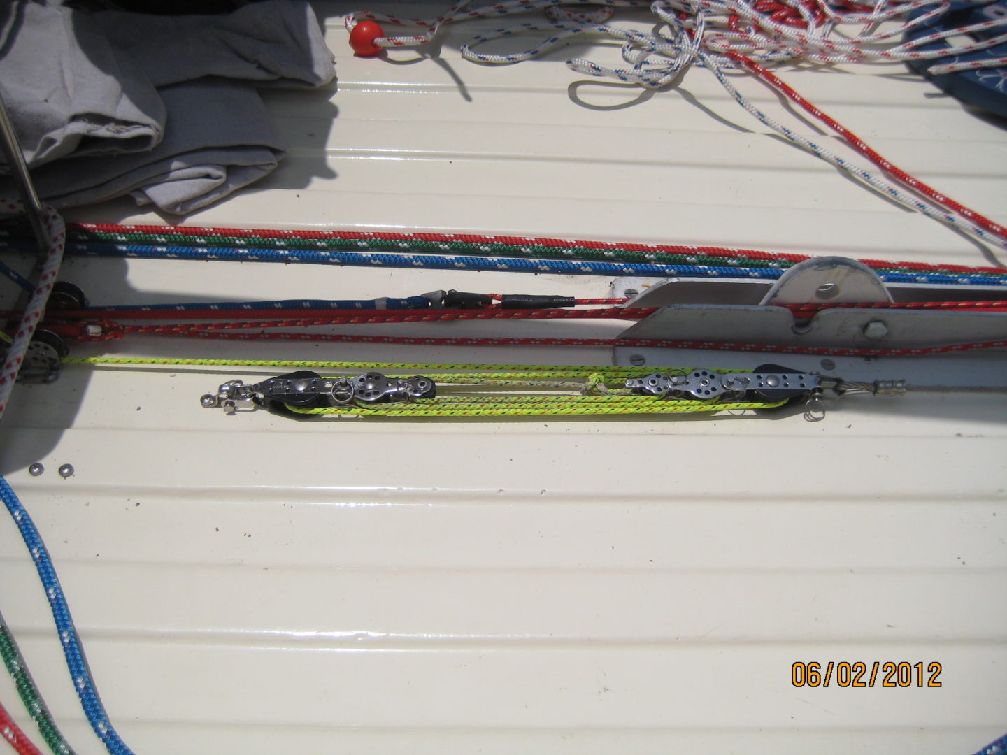 A pair of skis on the ground with some ropes