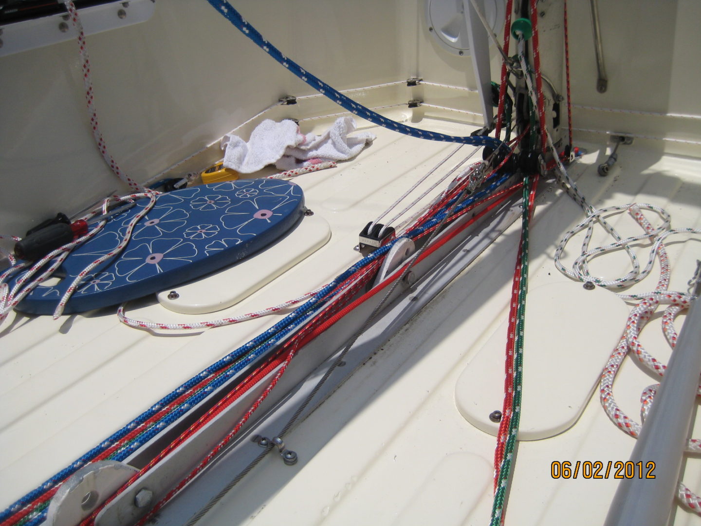 A boat with many ropes on the deck