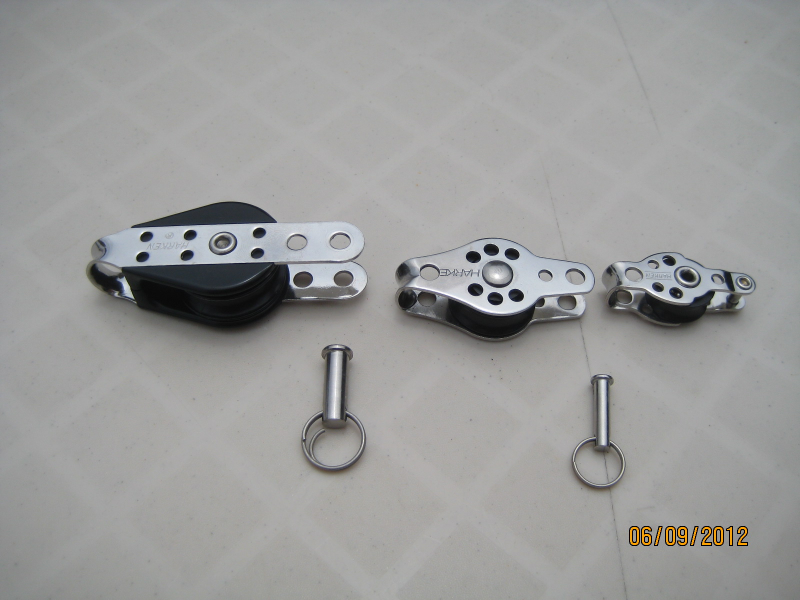 A pair of metal pulleys with two sets of keys.