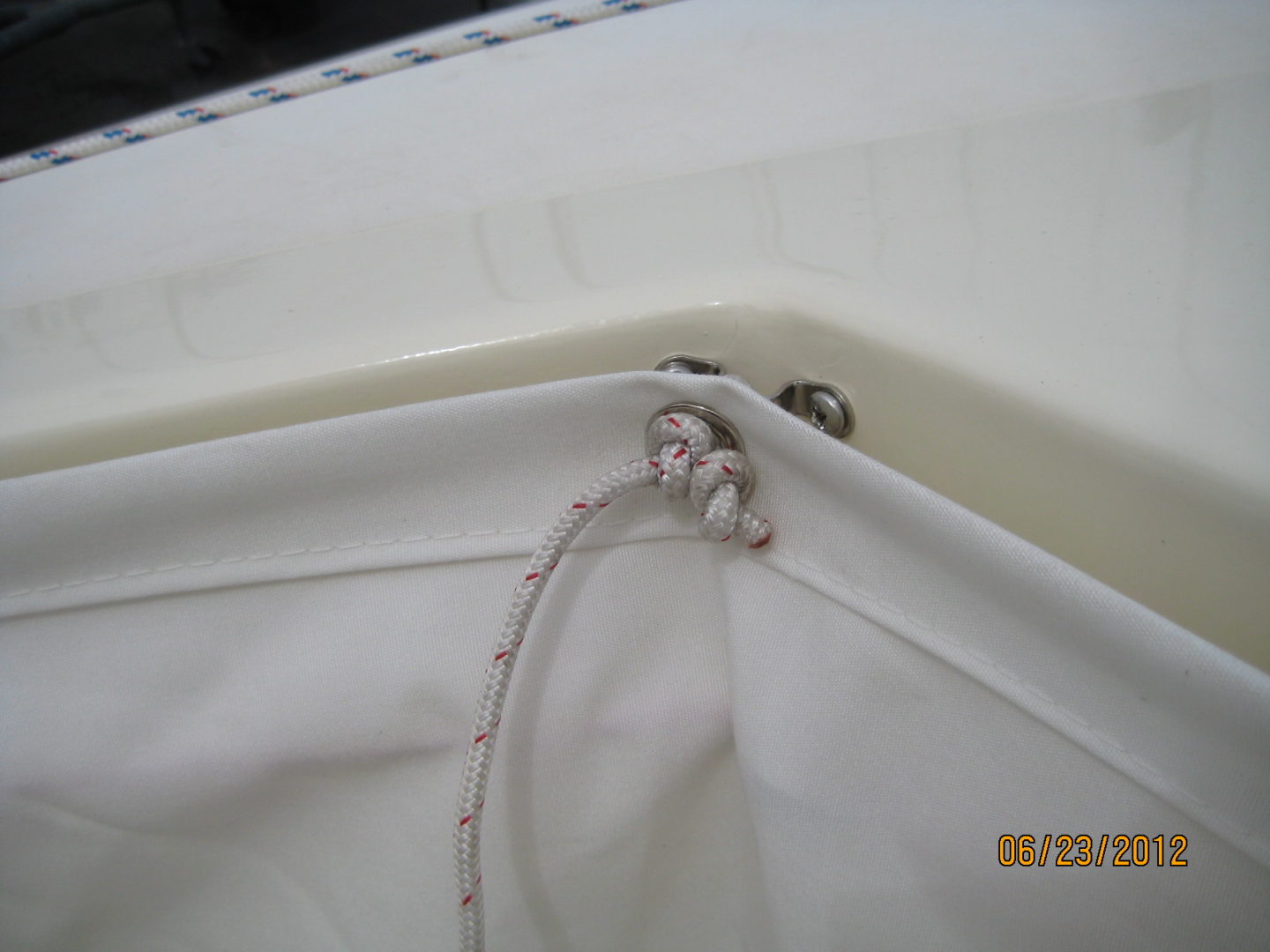 A white cloth with two wires hanging from it.