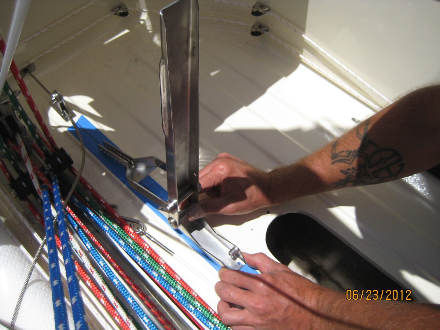 A person cutting paper with scissors and knife.