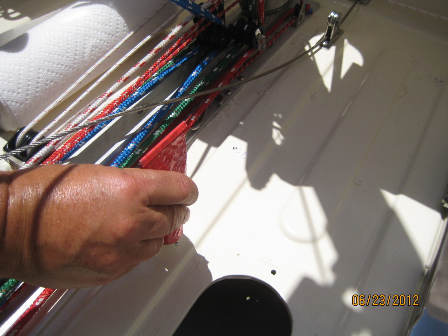 A person is working on wires in the sun.