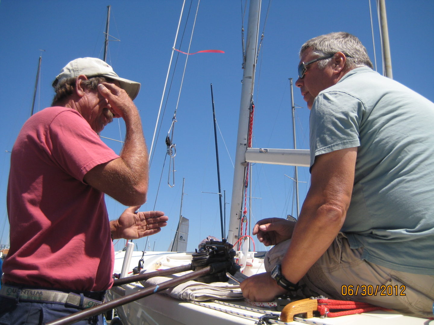 Two men sitting on a boat talking to each other.