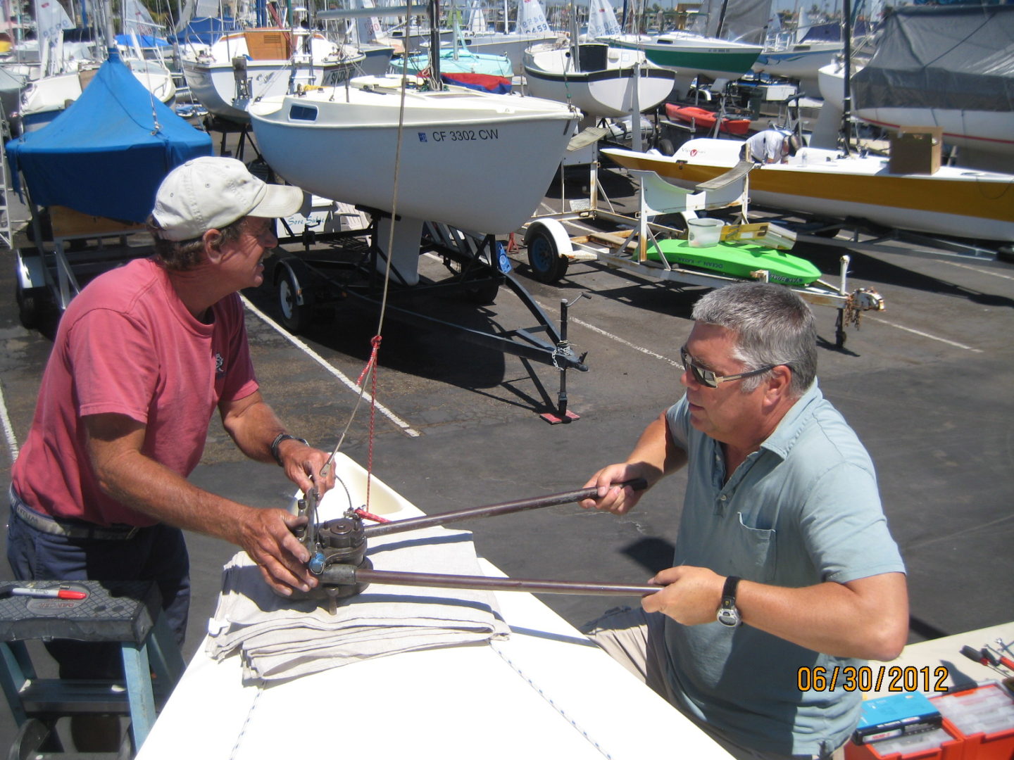 Two men are working on a boat.