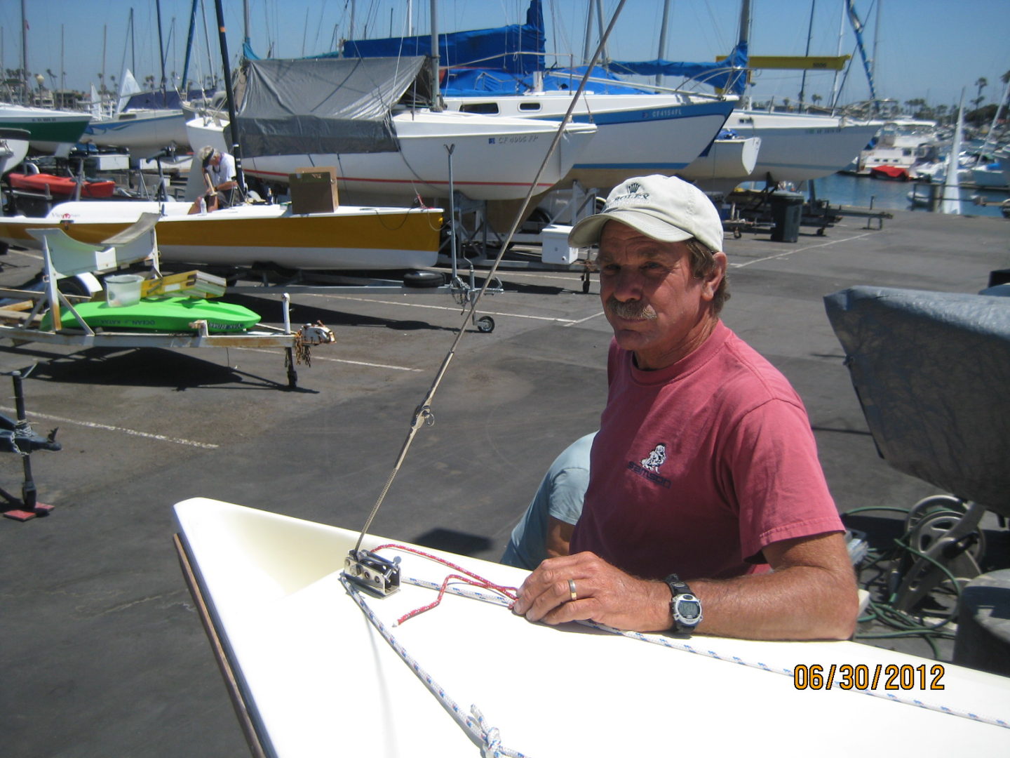 A man sitting on top of a boat in the water.