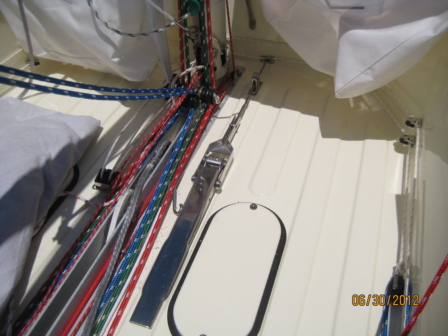 A boat with many ropes on the deck.