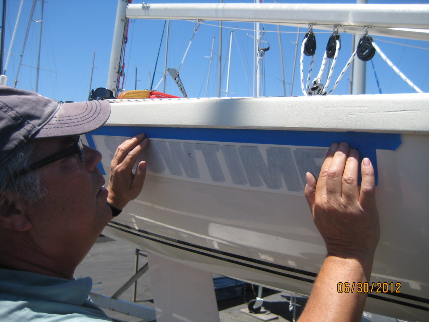 A man working on the side of a boat.