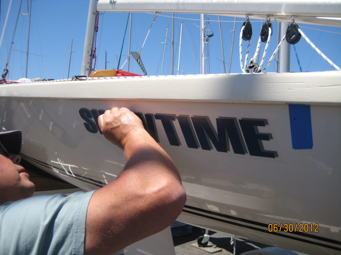 A man is holding the side of a boat