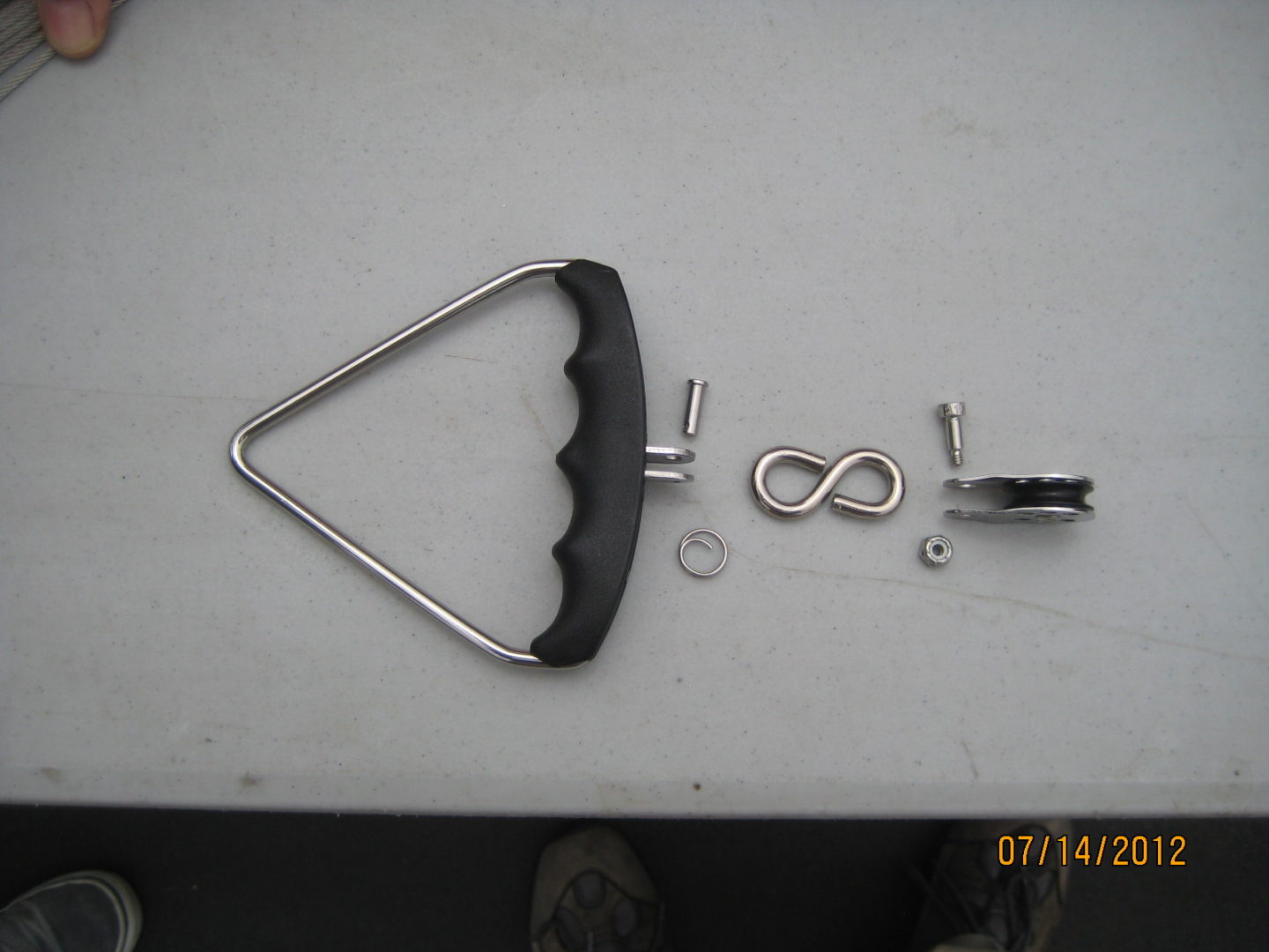 A metal triangle with some hardware on top of it