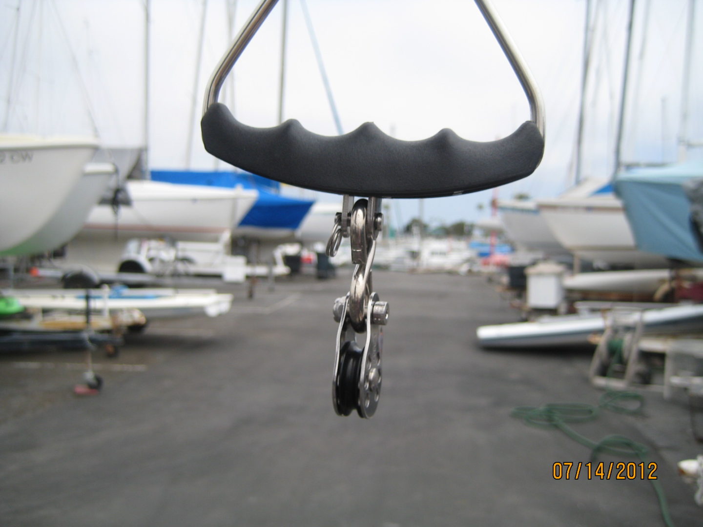 A bicycle hanging from the side of a boat.