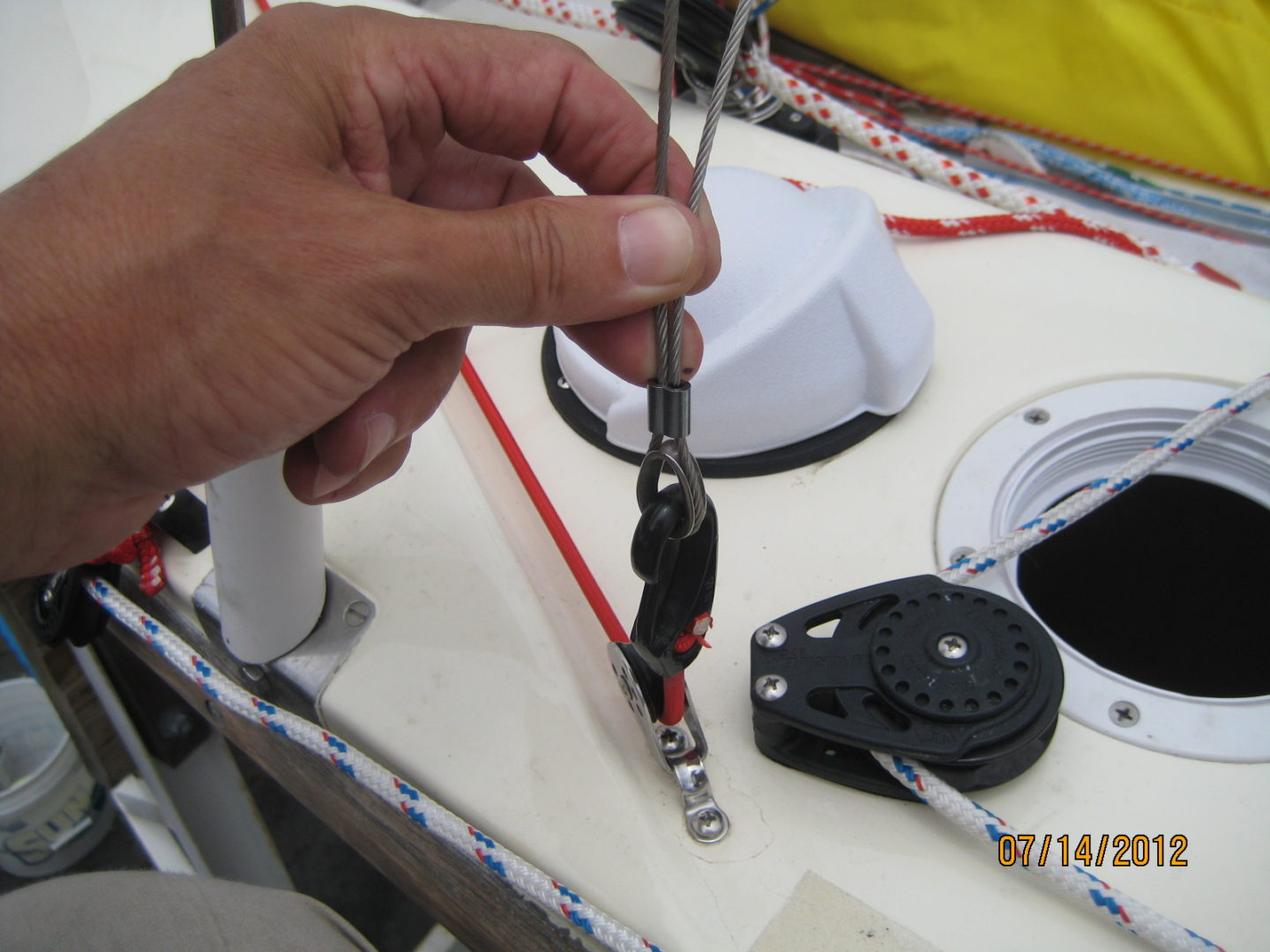 A person is using a pair of scissors to cut the wire.