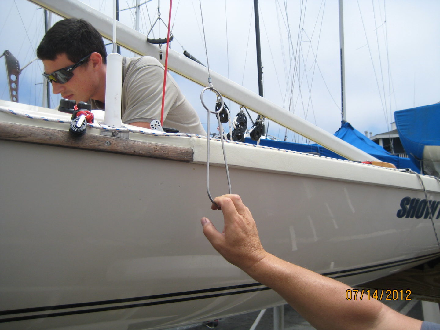 A man holding onto the side of a boat