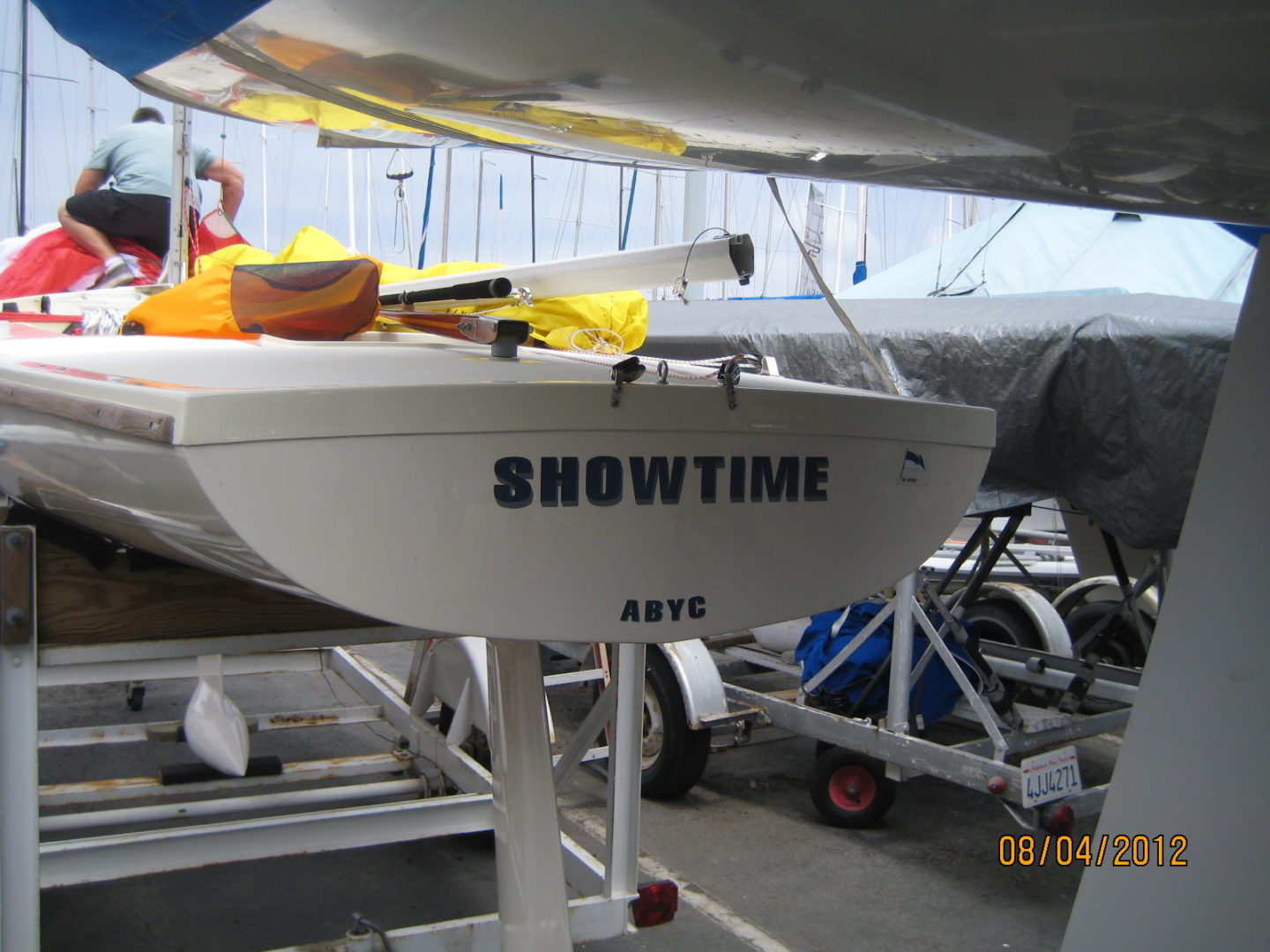 A boat is parked in the dock with other boats.