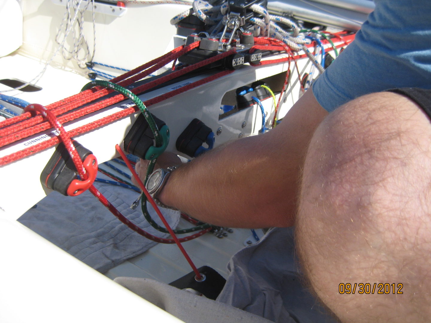 A person is holding onto some wires on the boat.