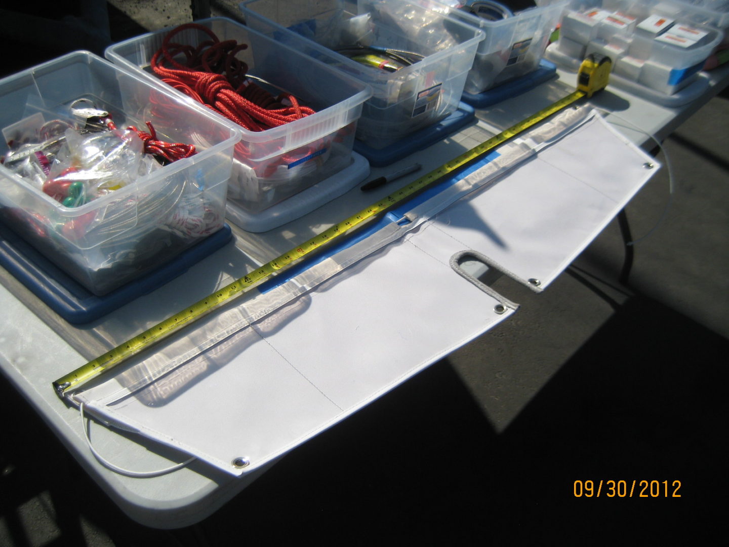 A table with some plastic containers and a ruler